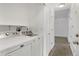 Laundry room has white washer and dryer and plenty of shelf space at 3261 S Waco Ct # K, Aurora, CO 80013