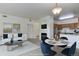 Comfortable living room featuring a fireplace, modern decor, and an adjoining kitchen with stainless steel appliances at 3261 S Waco Ct # K, Aurora, CO 80013