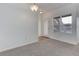 View of the spacious living room with neutral carpet, and a door to the outside at 3261 S Waco Ct # K, Aurora, CO 80013