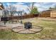 Backyard featuring a cozy fire pit area and a pergola-covered patio at 9510 Flower St, Broomfield, CO 80021