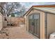 Backyard shed with double doors, in a gravel yard and wood fence at 9510 Flower St, Broomfield, CO 80021