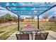 Backyard patio featuring a pergola with string lights for outdoor dining at 9510 Flower St, Broomfield, CO 80021