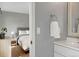 Bright view into bedroom from the gray bathroom, with light wood flooring at 9510 Flower St, Broomfield, CO 80021