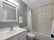 Bathroom with a white vanity, toilet, and a tub-shower combination with tiled walls at 9510 Flower St, Broomfield, CO 80021