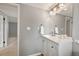 Bathroom featuring gray paint, wood floor, sink, mirror and lights at 9510 Flower St, Broomfield, CO 80021