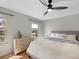 Cozy bedroom with a ceiling fan, gray walls, and light wood floors at 9510 Flower St, Broomfield, CO 80021