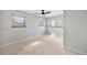 A bright, airy bedroom featuring three windows and a modern ceiling fan at 9510 Flower St, Broomfield, CO 80021