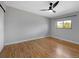 Empty bedroom features wood flooring, ceiling fan, and a window view at 9510 Flower St, Broomfield, CO 80021