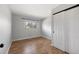 Empty bedroom features wood flooring, neutral walls, closet, and a window at 9510 Flower St, Broomfield, CO 80021