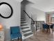 Bright dining area with stairs and modern decor, complemented by neutral walls and a stylish mirror at 9510 Flower St, Broomfield, CO 80021