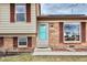 Charming two-story home with brick accents and a bright blue front door and red shutters at 9510 Flower St, Broomfield, CO 80021