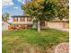 Charming two-story home with brick accents, a well-manicured lawn, and mature landscaping at 9510 Flower St, Broomfield, CO 80021