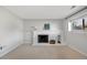 Living room with fireplace, light paint and carpeted floor; a window and modern furnishings give it a cozy atmosphere at 9510 Flower St, Broomfield, CO 80021