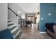 Open-plan living area with staircase, dining area, and comfortable seating on gray floors at 9510 Flower St, Broomfield, CO 80021