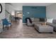 Inviting living room featuring modern gray floors, a blue accent wall, and comfortable seating at 9510 Flower St, Broomfield, CO 80021