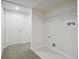 Basement laundry area with washer and dryer hookups and carpeted hallway at 3596 E Fair Pl, Centennial, CO 80121