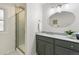 Bathroom featuring gray vanity with granite counters and a tile shower at 3596 E Fair Pl, Centennial, CO 80121