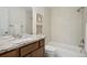 Bathroom with granite vanity, tub and shower combo with tile surround at 3596 E Fair Pl, Centennial, CO 80121