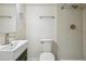 Bathroom with white tiles, updated fixtures, black vanity with basin sink, and modern toilet at 3596 E Fair Pl, Centennial, CO 80121