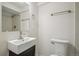 Bathroom with white tiles, updated fixtures, black vanity with basin sink, and modern toilet at 3596 E Fair Pl, Centennial, CO 80121