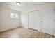 Bedroom with wood floors, window, and double door closet at 3596 E Fair Pl, Centennial, CO 80121