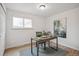 Bedroom with wood floors and large window being used as an office at 3596 E Fair Pl, Centennial, CO 80121