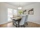 Stylish dining area with modern table, chandelier, and sliding glass door leading to the outdoors at 3596 E Fair Pl, Centennial, CO 80121