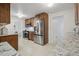 Well-lit kitchen featuring stainless steel appliances, granite counters, and adjacent rooms at 3596 E Fair Pl, Centennial, CO 80121