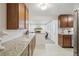 Open kitchen design with granite countertops, ample cabinetry, and view of adjacent living area at 3596 E Fair Pl, Centennial, CO 80121