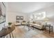 Bright and airy living room featuring hardwood floors, neutral decor, and ample natural light at 3596 E Fair Pl, Centennial, CO 80121