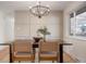 Modern dining room with a dark wood table and chandelier at 4751 S Xenia St, Denver, CO 80237