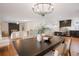 Bright dining room featuring a dark wood table and chandelier at 4751 S Xenia St, Denver, CO 80237