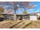 Gray brick Ranch home with a large tree and attached garage at 4751 S Xenia St, Denver, CO 80237