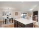 Open concept kitchen with island and view of dining area at 4751 S Xenia St, Denver, CO 80237