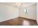 Comfortable bedroom with ceiling fan, hardwood floors, and a bright window at 13020 E Linvale Pl, Aurora, CO 80014