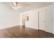 Spacious bedroom with ceiling fan, dark wood floors, and ample closet space at 13020 E Linvale Pl, Aurora, CO 80014