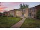 Charming townhome with landscaped front yard and inviting entryway at sunset at 13020 E Linvale Pl, Aurora, CO 80014