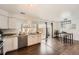 Modern kitchen with stainless steel appliances, granite countertops, and adjacent dining area at 13020 E Linvale Pl, Aurora, CO 80014