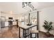 Bright eat-in kitchen with stainless appliances, modern lighting, and sliding glass doors to the outside at 13020 E Linvale Pl, Aurora, CO 80014