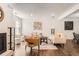 Open living room with hardwood floors, fireplace, and bright natural light at 13020 E Linvale Pl, Aurora, CO 80014