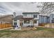 Backyard features a pergola patio, lush grass, and fenced perimeter for privacy and enjoyment at 9821 Rock Dove Ln, Highlands Ranch, CO 80129