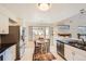 Spacious kitchen with stainless steel appliances, white cabinets, and a cozy eat-in area for casual dining and entertaining at 9821 Rock Dove Ln, Highlands Ranch, CO 80129