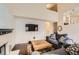 Bright living room with hardwood floors, neutral walls, modern fireplace, and comfortable seating, perfect for relaxation at 9821 Rock Dove Ln, Highlands Ranch, CO 80129