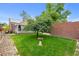 View of the backyard highlighting a tree, a bird bath and a detached sunroom at 1429 Hudson St, Denver, CO 80220