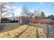 Large backyard featuring a detached garage and outdoor seating area, perfect for entertaining and relaxation at 1429 Hudson St, Denver, CO 80220