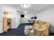 Finished basement with carpet, two chairs, a patterned couch, and a small desk area at 1429 Hudson St, Denver, CO 80220