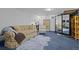 Spacious basement living space with comfortable seating and a large mirror at 1429 Hudson St, Denver, CO 80220