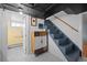 Basement stairway adjacent to an updated basement bathroom featuring white tile floors at 1429 Hudson St, Denver, CO 80220