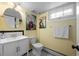 Basement bathroom with art, updated fixtures and yellow walls at 1429 Hudson St, Denver, CO 80220