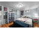 Basement bedroom with light blue walls, wood floors, and white trim at 1429 Hudson St, Denver, CO 80220